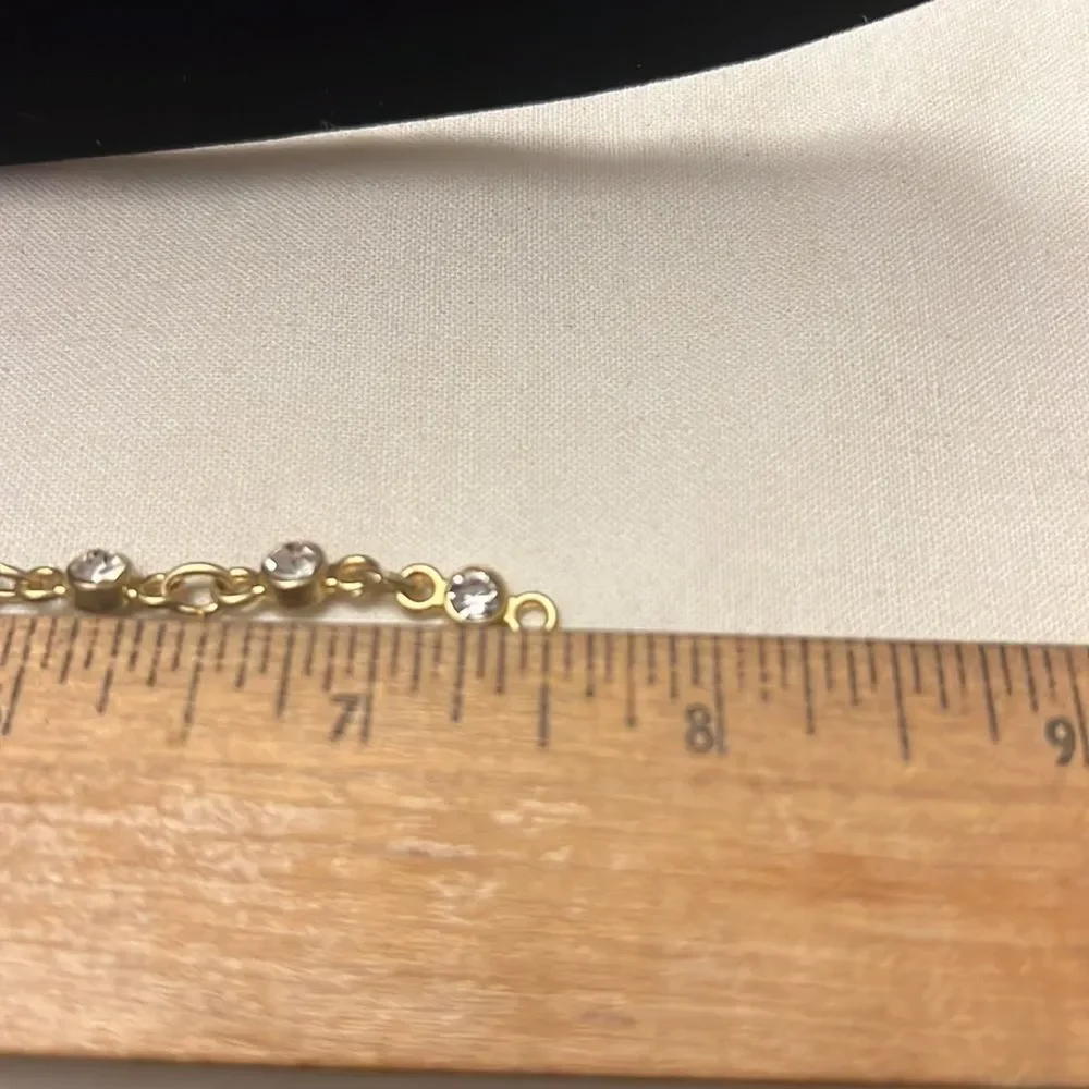 Handcrafted gold tone bracelet with clear stone detail
